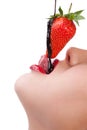 Girl eating strawberry with chocolate sauc