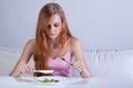 Girl eating very small lunch Royalty Free Stock Photo