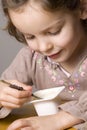 Girl eating yogurt Royalty Free Stock Photo