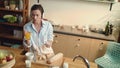 Girl eating yogurt baguette grapes in kitchen. Woman drinking orange juice. Royalty Free Stock Photo