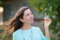 The girl eats cherries. walking down the street, lively emotions, attractive young woman bare shoulders hold cherry open mouth Royalty Free Stock Photo