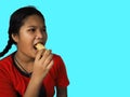 The girl eats hot dog Happily Isolated on a yellow background. Embed clipping path. Junk food concept. Royalty Free Stock Photo