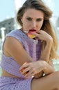 Girl eats a red apple with a knife. Royalty Free Stock Photo