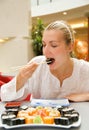 Girl eats sushi Royalty Free Stock Photo