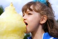 The girl eats sweet cotton wool Royalty Free Stock Photo