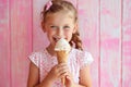 Girl Eats Vanilla Ice Cream On Pastel Background