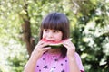 Girl eats watermelon outdoors