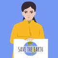 Girl eco activist holds poster. Save the earth. Globe planet drawing. Young female in yellow coat protest agains global warming