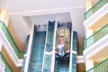 Girl in the elevator lobby of the arabic hotel. Palm tree and balconi in a hotel building in Tunisia, Africa Royalty Free Stock Photo