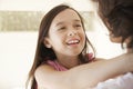 Girl Embracing Mother At Home