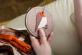 Girl embroiders a bird with a stitch. DIY concept, Hobbies, creativity, clothing and interior decoration Royalty Free Stock Photo