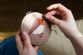 Girl embroiders a bird with a stitch. DIY concept, Hobbies, creativity, clothing and interior decoration Royalty Free Stock Photo