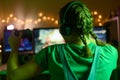 The girl emotionally plays video games with a headset, and a joystick, controller, gamepad. On the computer online with her Royalty Free Stock Photo