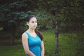 Girl is engaged in fitness in the park, doing exercises. Training on the street in the summer morning. Concept sport healthy Royalty Free Stock Photo