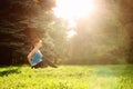 Girl is engaged in fitness in the park, doing exercises. Training on the street in the summer morning. Concept sport healthy Royalty Free Stock Photo