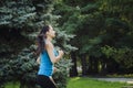 Girl is engaged in fitness in the park, doing exercises. Training on the street in the summer morning. Concept sport healthy Royalty Free Stock Photo