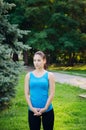 Girl is engaged in fitness in the park, doing exercises. Training on the street in the summer morning. Concept sport healthy Royalty Free Stock Photo