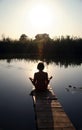Girl is engaged in meditation on the small bridge Royalty Free Stock Photo