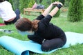 The girl is engaged in nature yoga. Pair yoga or acro yoga