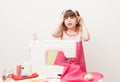 The girl is engaged in needlework using sewing machine Royalty Free Stock Photo