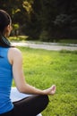 Girl is engaged in yoga in the park, doing exercises. Training on the street in the summer morning. Concept sport healthy Royalty Free Stock Photo