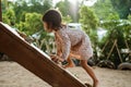 A girl enjoy playing on the wooden board climb alone