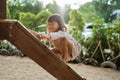 A girl enjoy playing on the wooden board climb alone