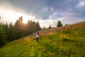 Girl enjoy pure nature. Walk over the field to meet sunset