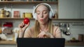 Girl enjoy remote work at kitchen in headphones close up. Woman listening music. Royalty Free Stock Photo