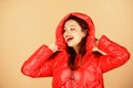 Girl enjoy wearing bright jacket with hood. Warm coat. Comfortable down jacket. Red color. Finding right winter jacket