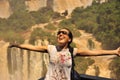 Girl enjoying the amazing Iguazu waterfall from below. Argentinian side