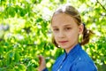 The girl is enjoying the apple blossom. A school-age child in a garden with tree flowers. Copy space Royalty Free Stock Photo