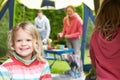 Girl Enjoying Family Camping Holiday On Campsite