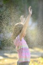 Girl enjoying the light summer rain.