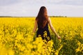 Girl enjoying rapeseed blooming on yellow meadow Royalty Free Stock Photo