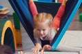 Girl enjoying a sensory therapy on a hammock while physiotherapist assisting her