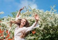 Girl enjoying springtime near blooming trees