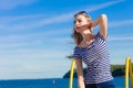 Girl enjoying summer breeze sky background Royalty Free Stock Photo