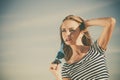 Girl enjoying summer breeze sky background Royalty Free Stock Photo