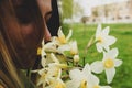 Girl enjoys the aroma of a bouquet of daffodils