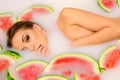 Girl enjoys a bath with milk and watermelon. Royalty Free Stock Photo