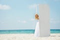 Girl entering open door on beach