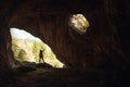 Girl in the entrance of a cave Royalty Free Stock Photo