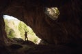 Girl in the entrance of a cave Royalty Free Stock Photo