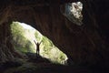 Girl in the entrance of a cave Royalty Free Stock Photo