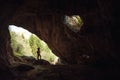 Girl in the entrance of a cave Royalty Free Stock Photo