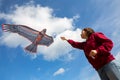 Girl launches a kite. Flying kite. Kite in the form of an eagle. Blue sky with clouds Royalty Free Stock Photo