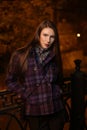 girl in the evening at night in the city on the street, cool, cold, with a round natural face, fashion, autumn
