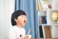 Girl with exaggerated expression at meal