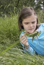 Girl Examining Caterpillar On Leaf